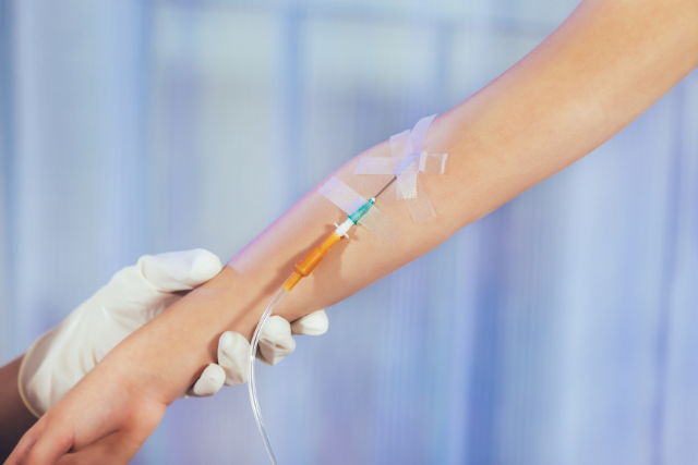 a nurse checking IV flow on patient