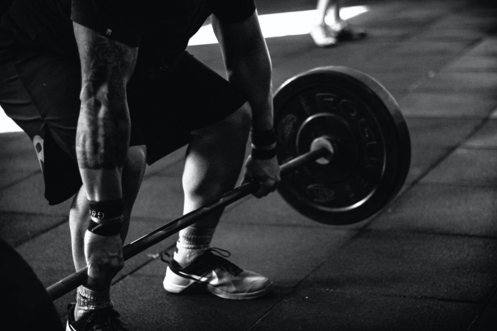 a fit guy lifting a barbell